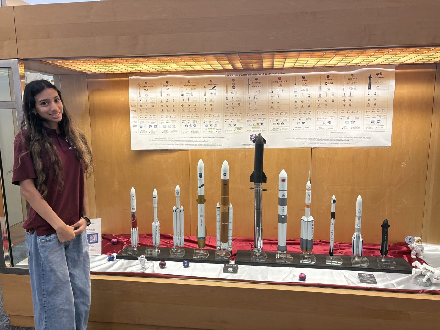 Saanvi Phaneendra standing next to the Fremont rocket display