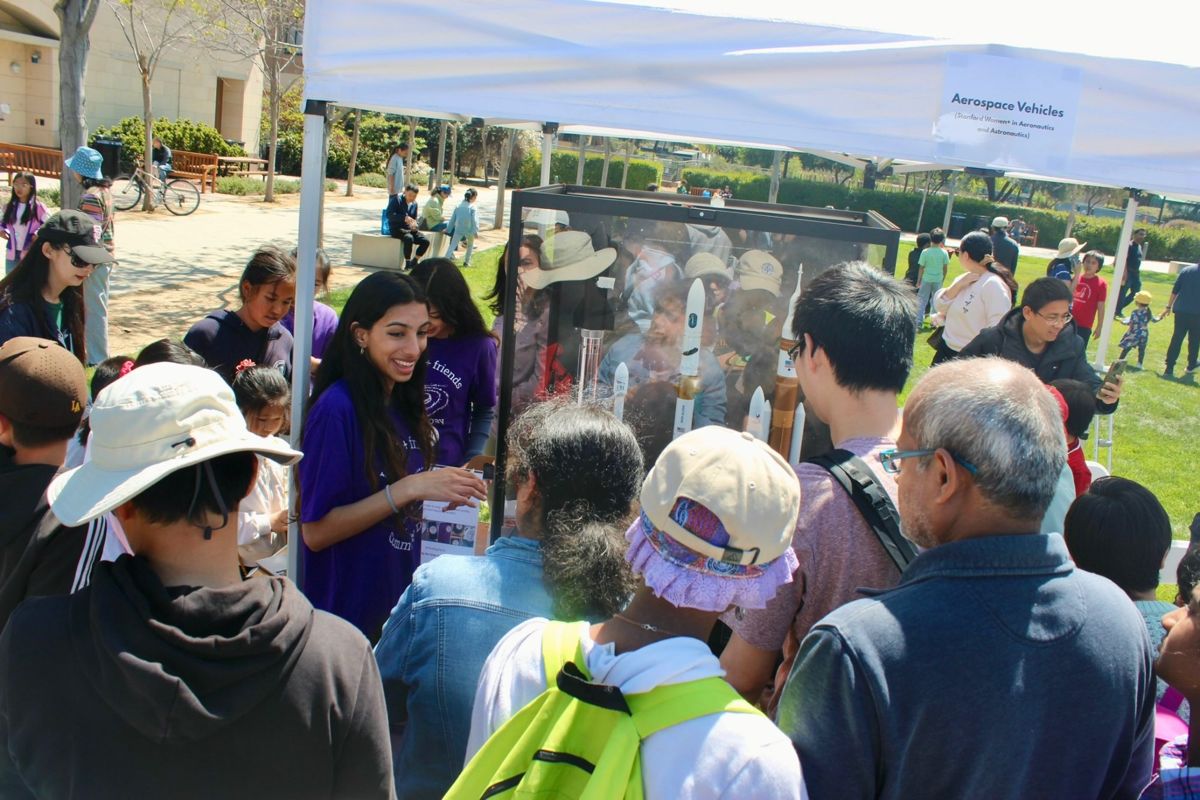 A crowd of kids and families around the Galactic Getaway rocket exhibit