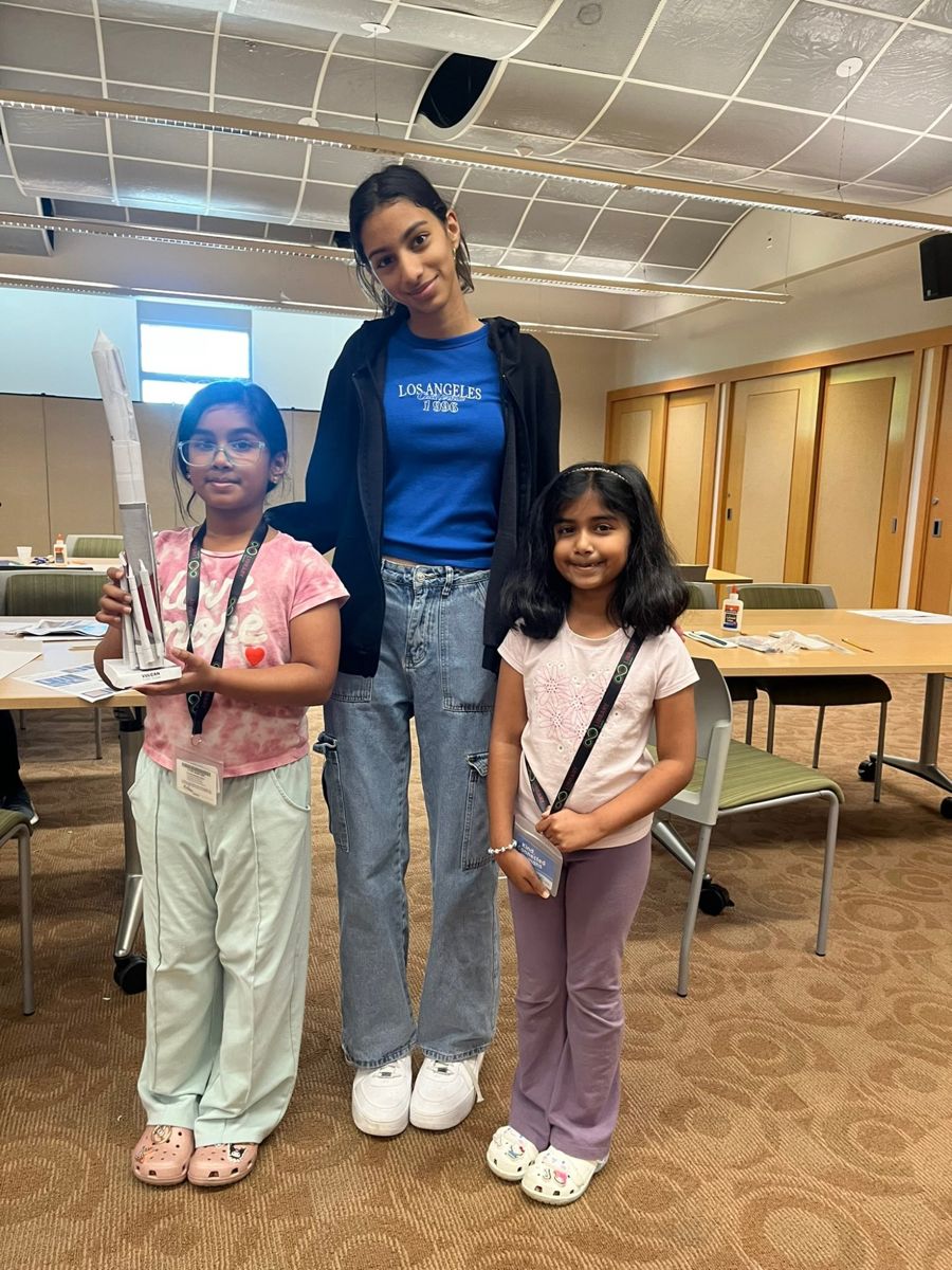 Young rocket builders holding their paper rockets with Saanvi Phaneendra