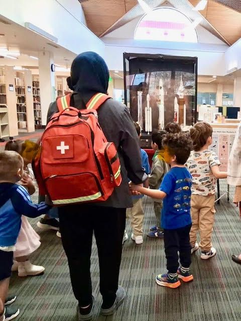 Kids lining up at a library to ask Saanvi Phaneendra questions about the rocket exhibit