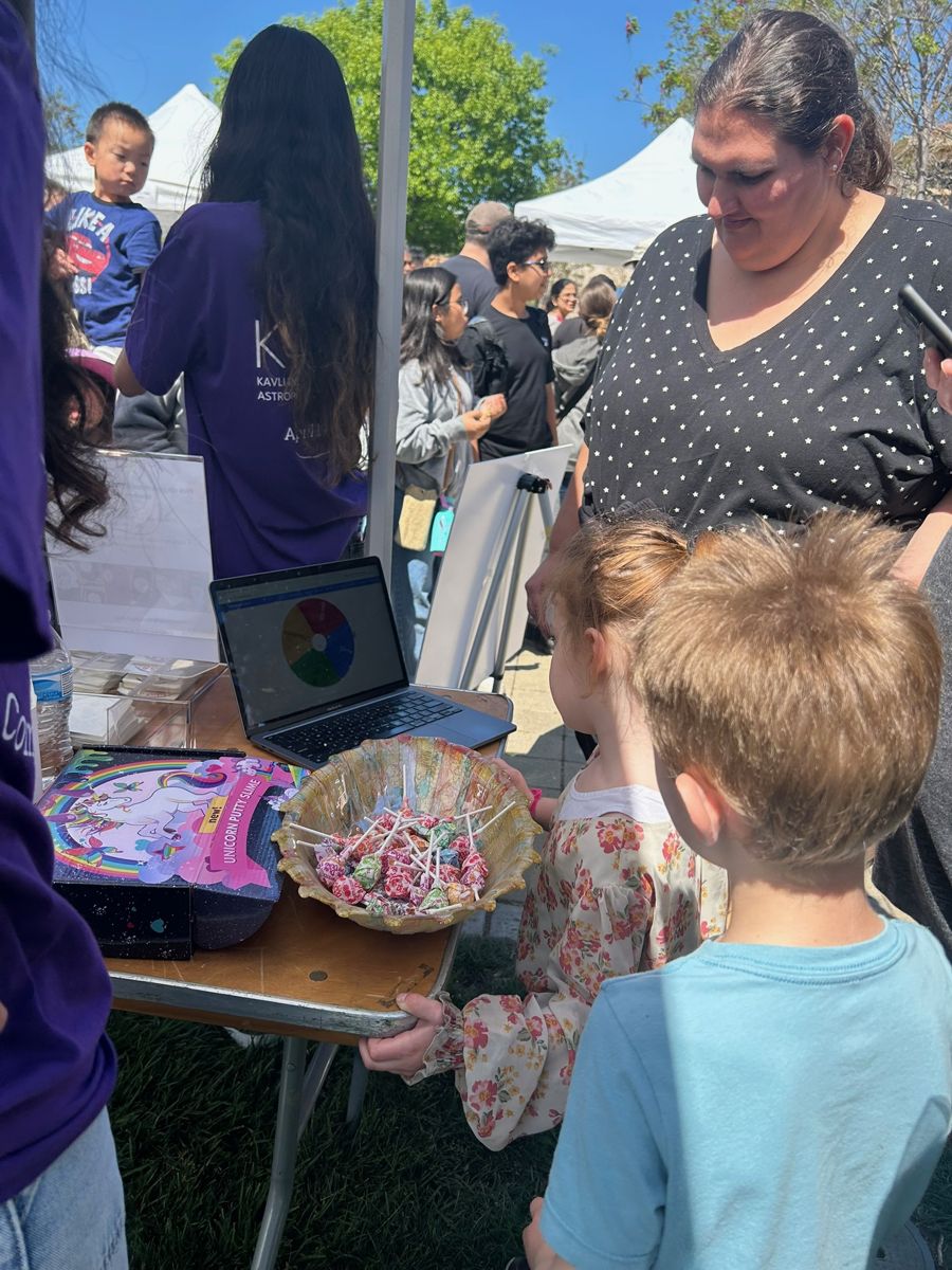 Children gathered at the Galactic Getaway table at a festival